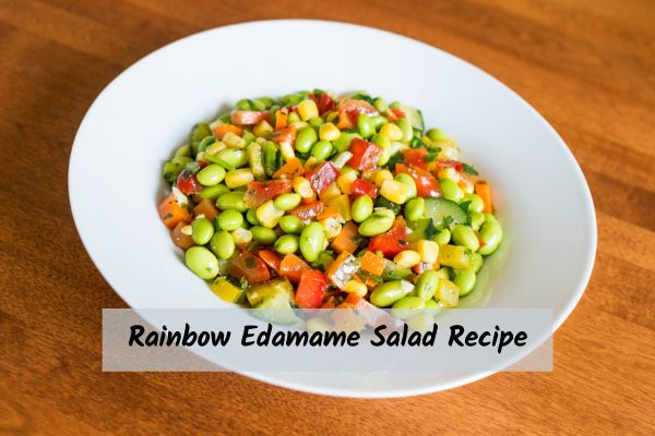 Rainbow edamame salad in a large white bowl
