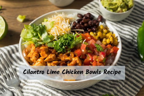 A bowl including chicken, corn, cilantro, rice, beans, cheese, and tomatoes on a striped placemat.