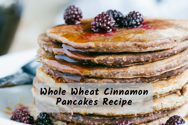 Whole_Wheat_Cinnamon_Pancakes a stack of whole wheat cinnamon pancakes with raspberries on top