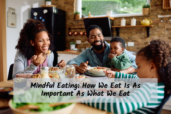 Mom, dad, and two kids sitting around a table eating together