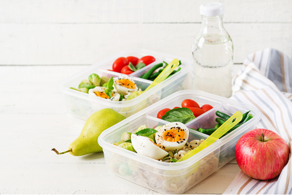 school lunch bento box with boiled egg, rice, fruits, and vegetables