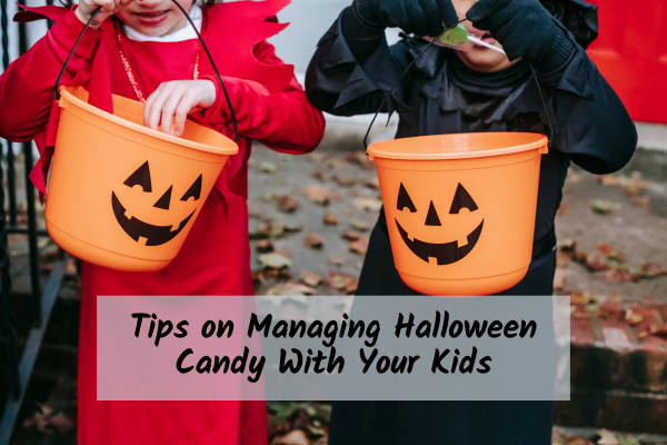 two kids holding baskets with Halloween candy