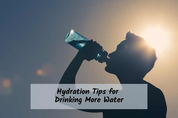 man drinking a bottle of water while outside in the sun