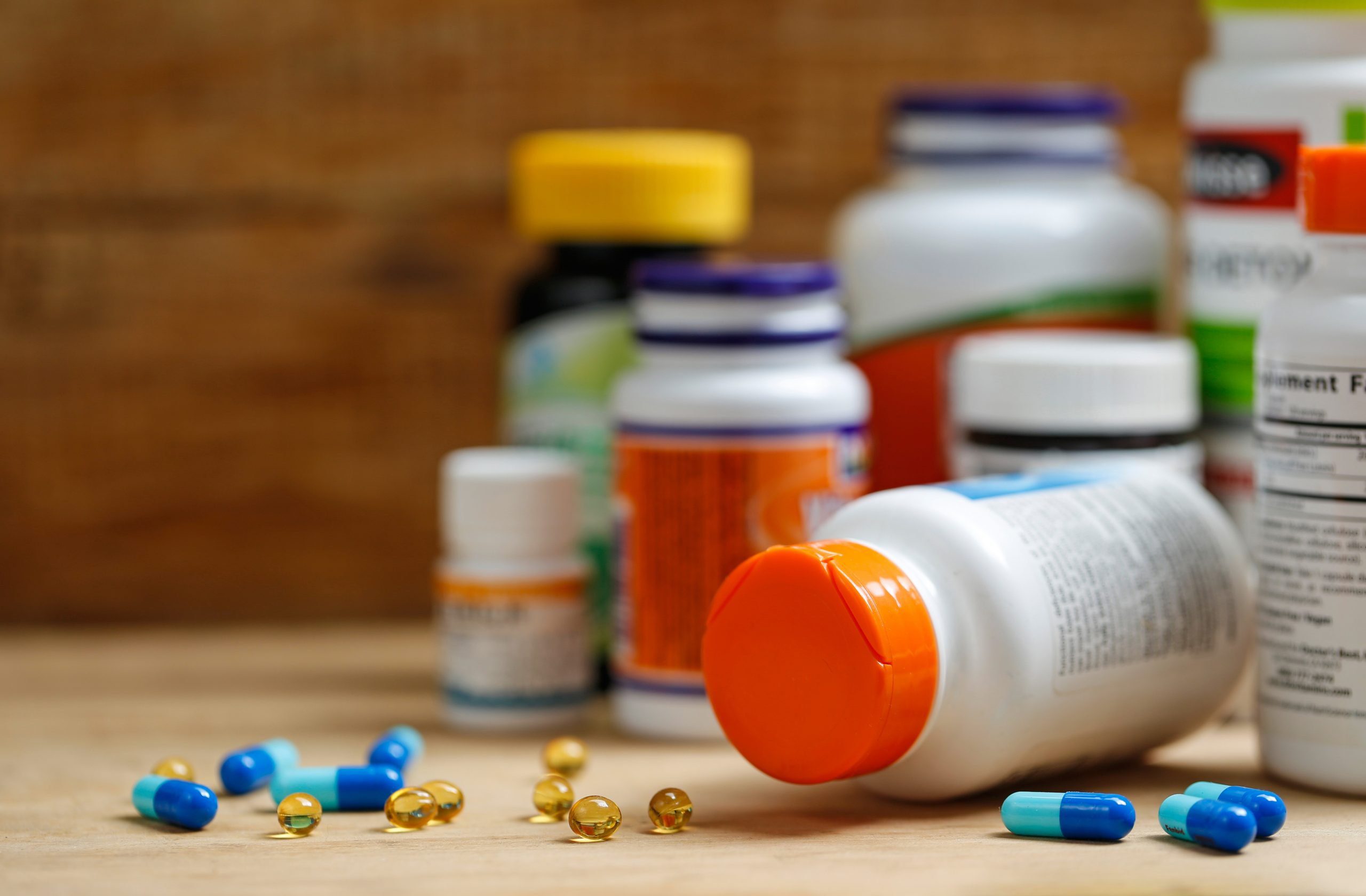 Medicine bottles and tablets on wooden desk probiotic supplement bottles and tablets on wooden desk