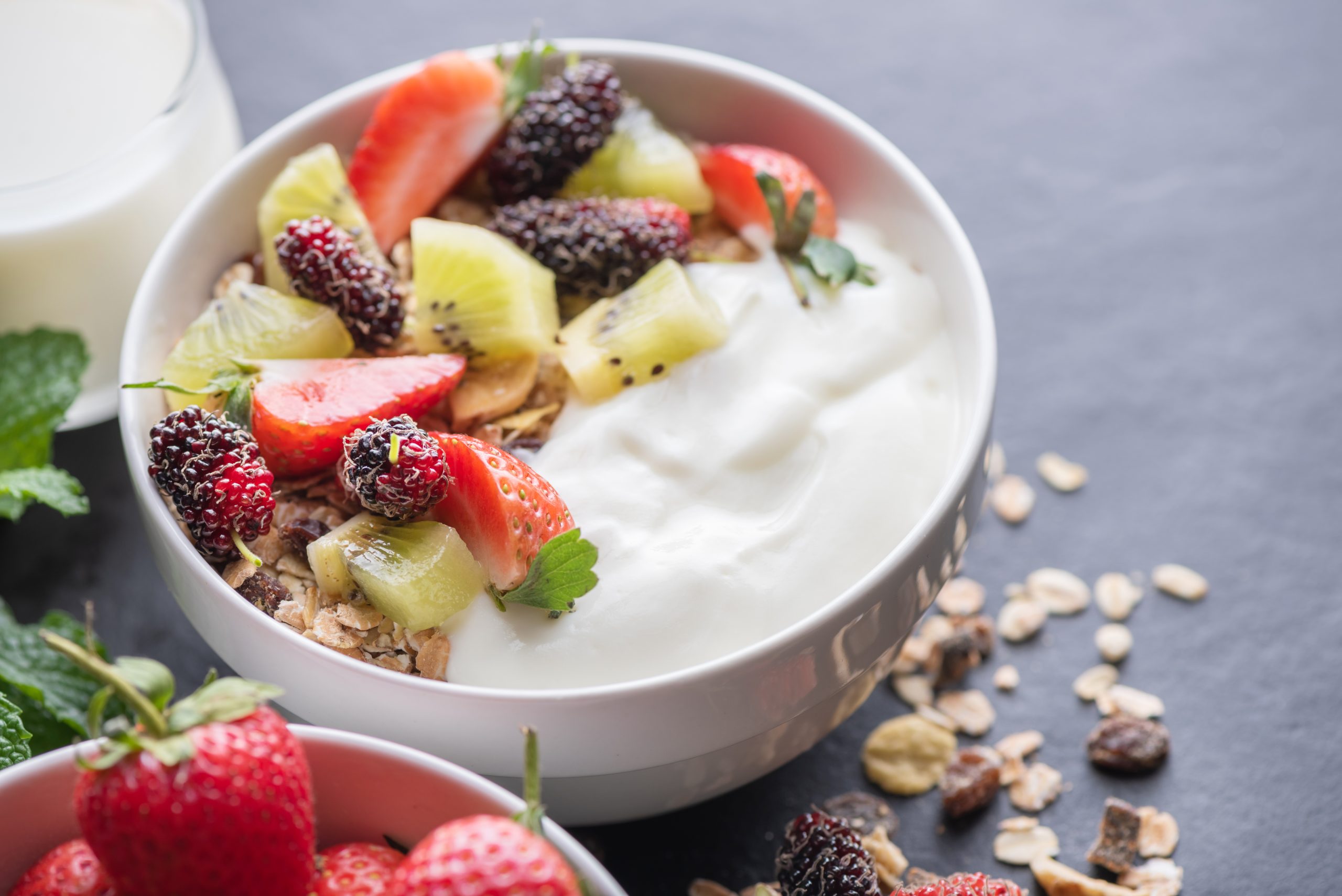 immune_boosting_supplements bowl of yogurt with strawberries, kiwis, and granola