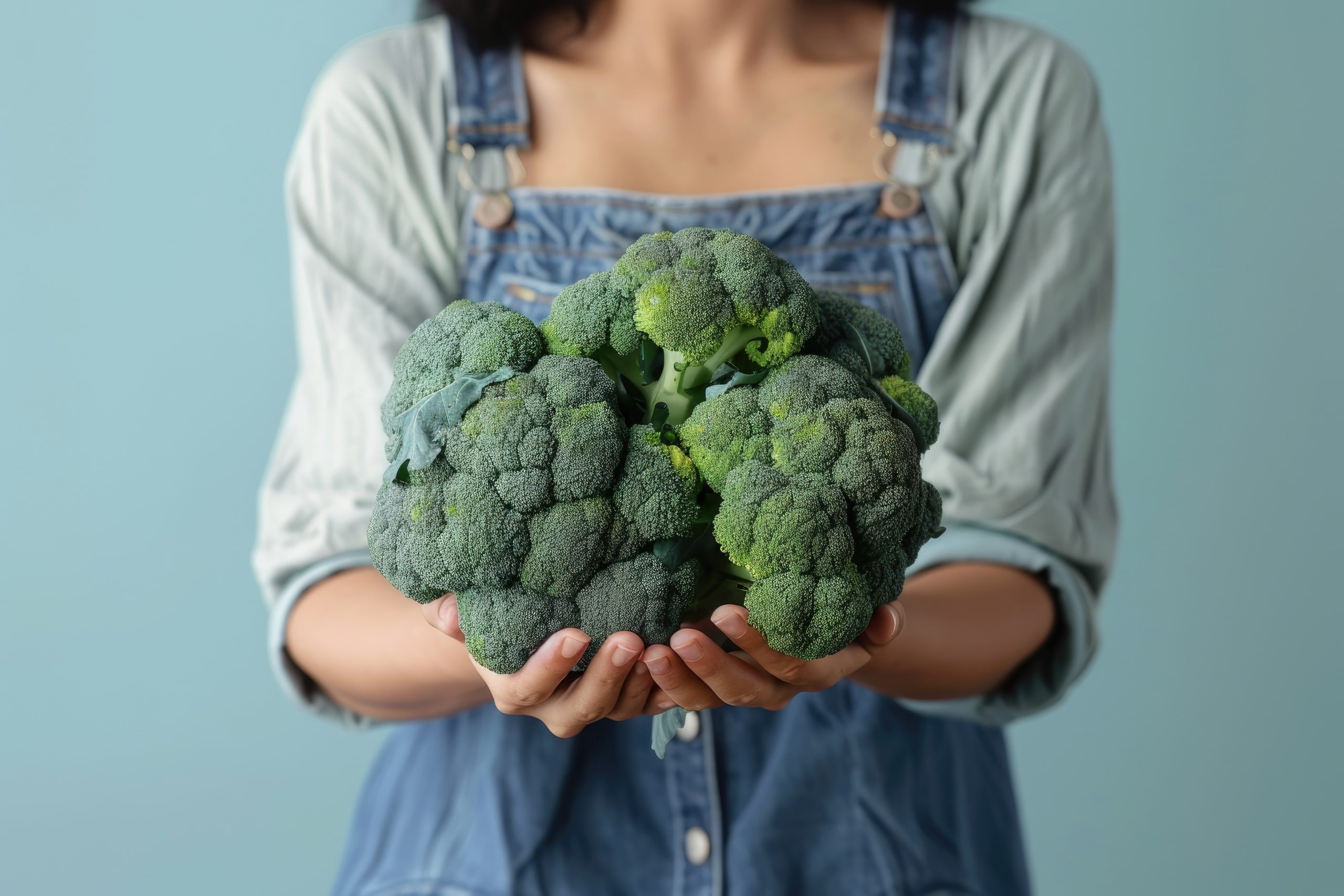 woman-holding-fresh-organic-broccoli Broccoli