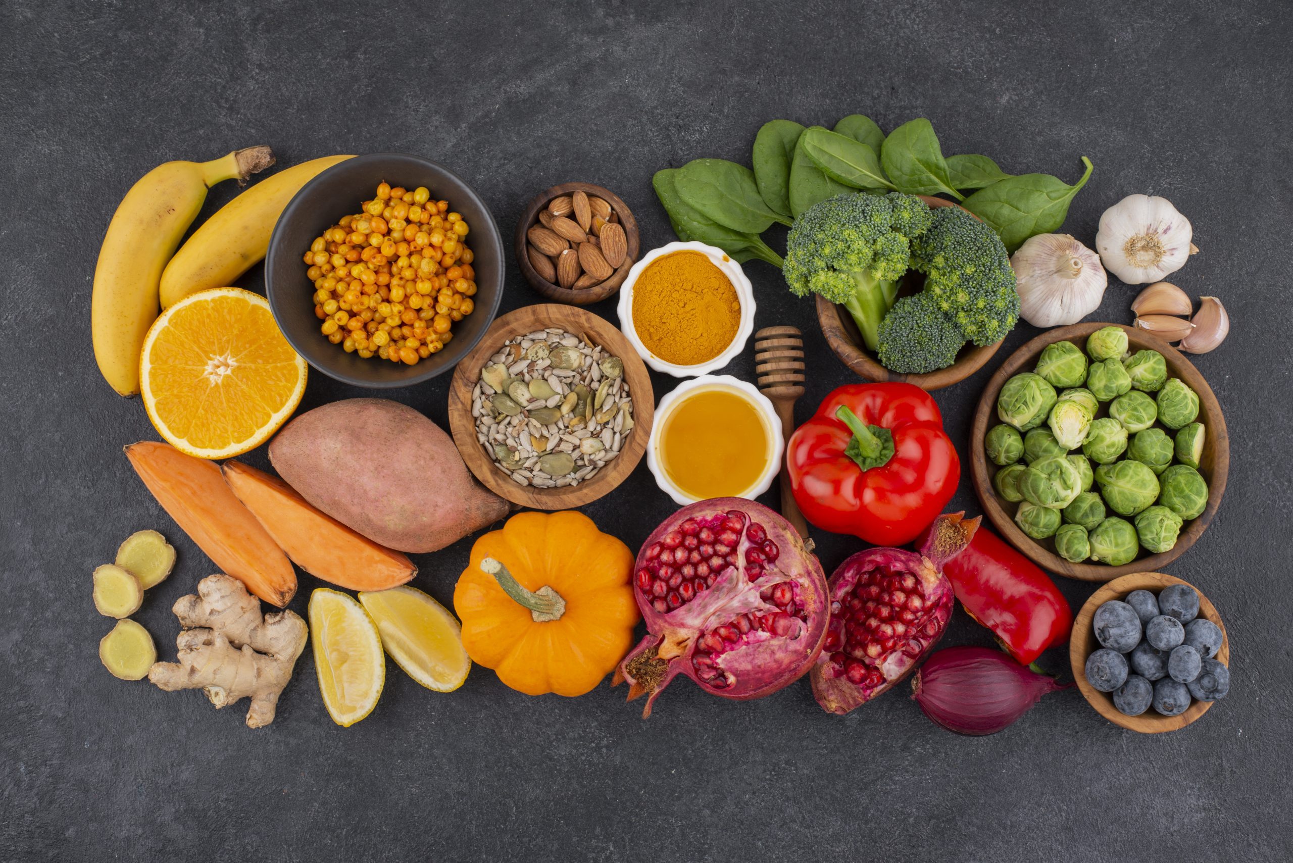 top view of a variety of fruits, vegetables, legumes, and nuts and seeds