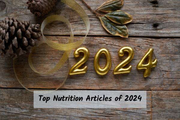 2024 numbers on a wooden table with pine cone decorations