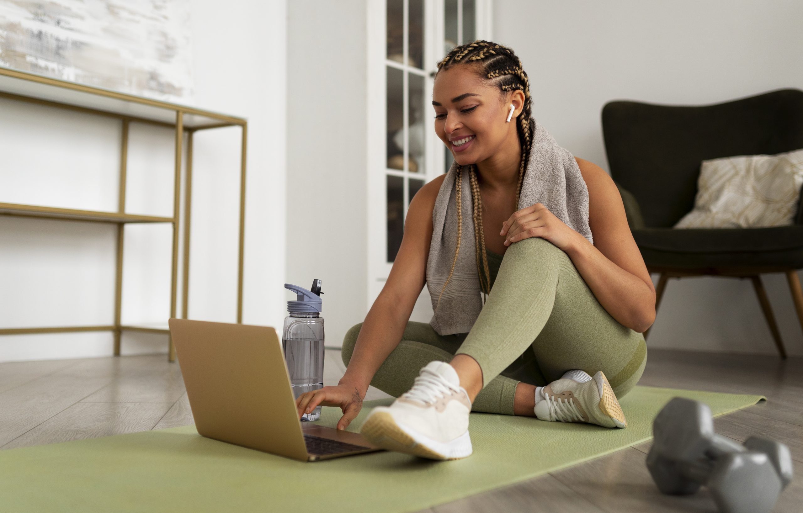 tips_for_managing_high_blood_pressure Woman on yoga mat working out with laptop