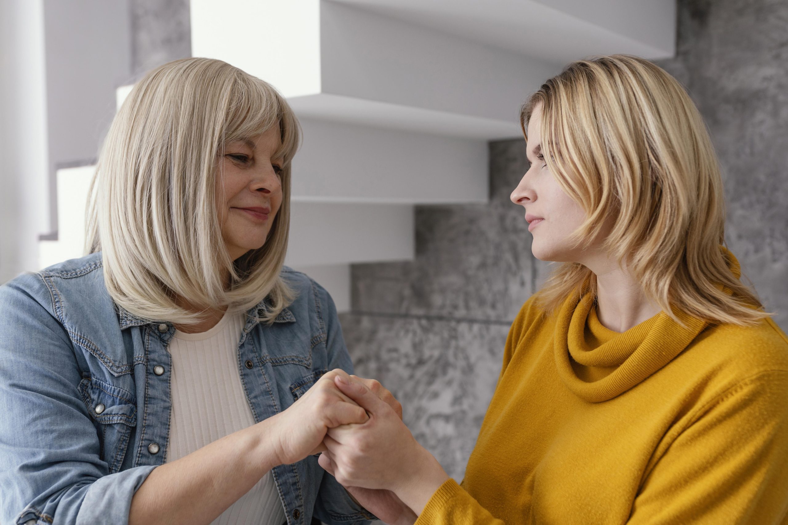 women holding hands supporting each other