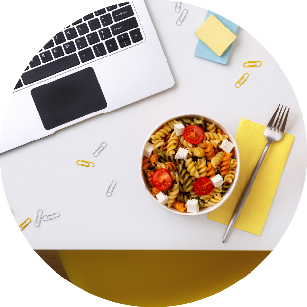 Workplace_Nutrition_Seminars a desk with pasta next to a laptop