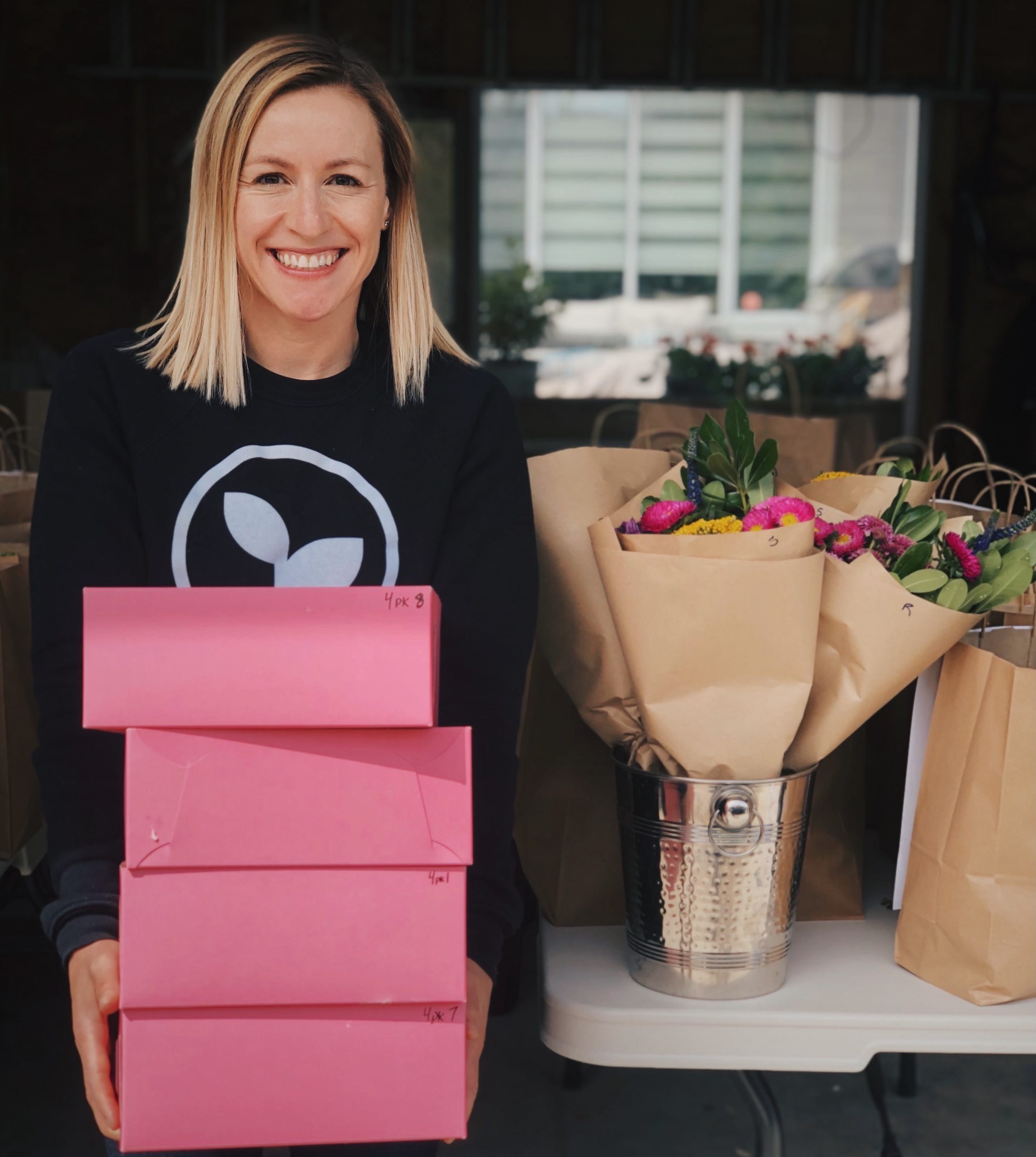 Processed with VSCO with hb2 preset dawn standing smiling holding boxes with flowers nearby