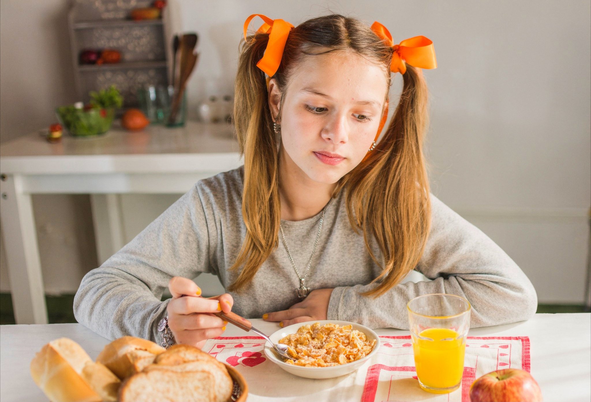 adhd-nutrition-for-kids-preteen preteen looking down at her breakfast
