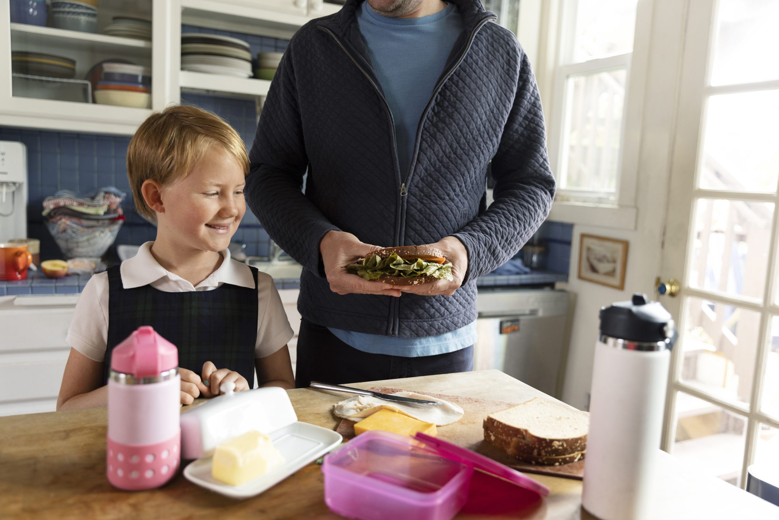 dad-preparing-kid-first-day-school dad preparing lunch for kid with adhd