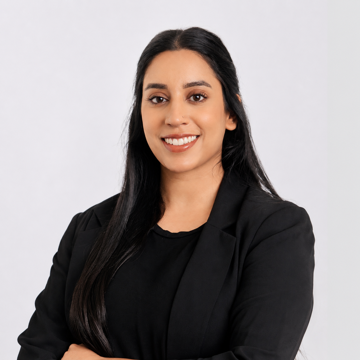 Registered Dietitian Gurveen Jaggi in a black blazer smiling  at the camera