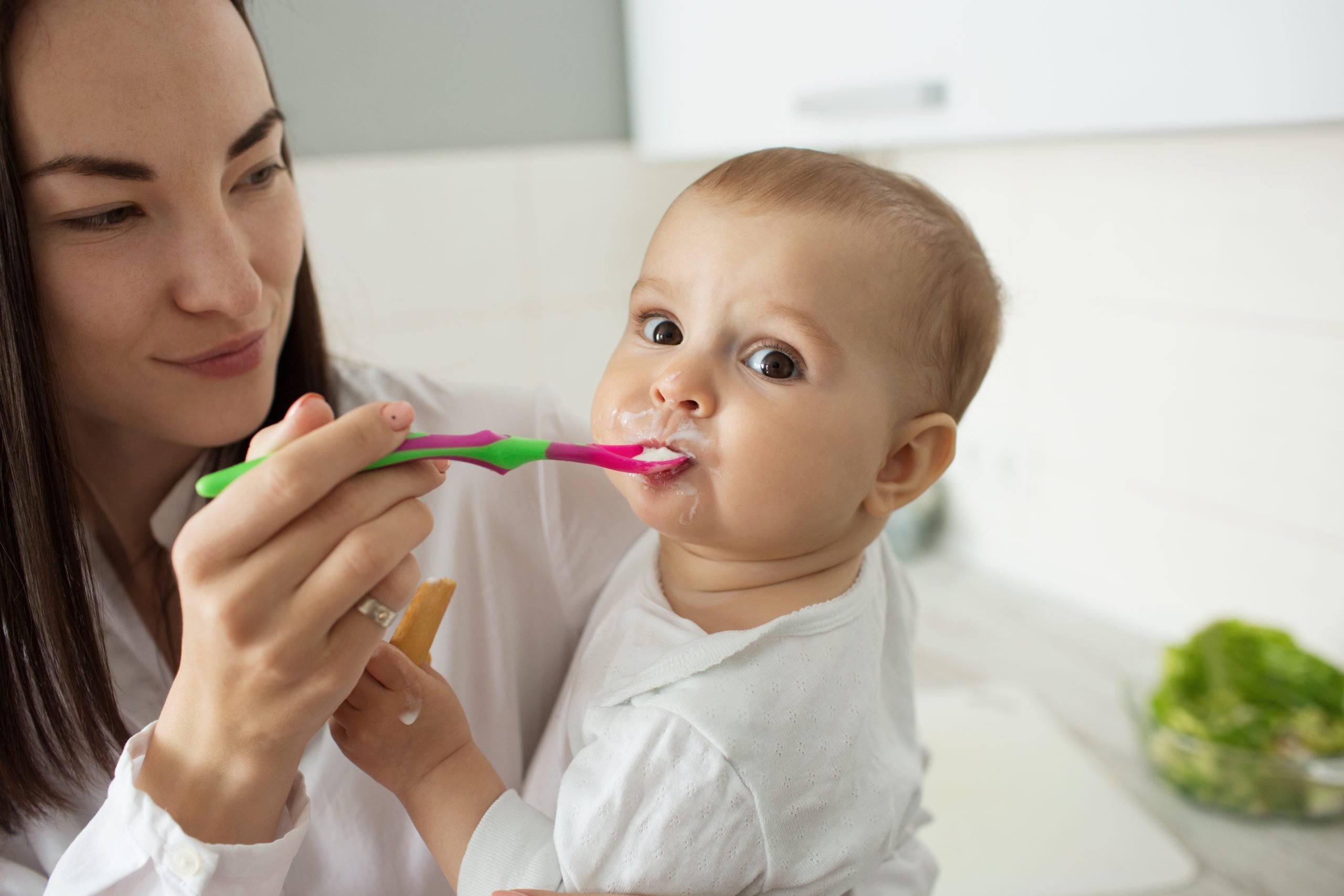 starting_solids mom feeding baby solid foods on spoon